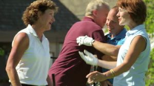 stock-footage-a-group-of-old-friends-meet-on-the-golf-course-and-say-hello-with-hugs-and-smiles
